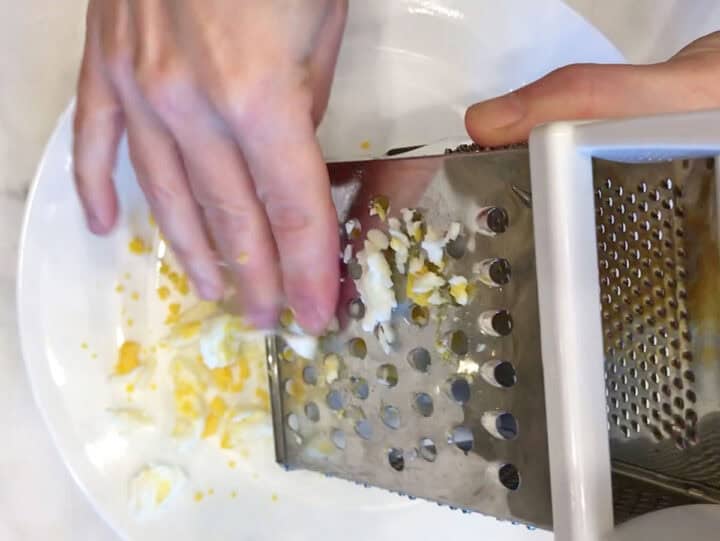 Grating the eggs.