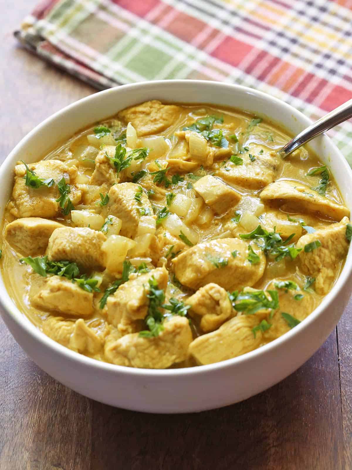 Thai chicken curry is served in a white bowl.
