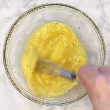 Mixing the eggs in a bowl.