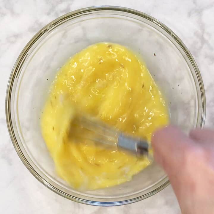 Mixing the eggs in a bowl.