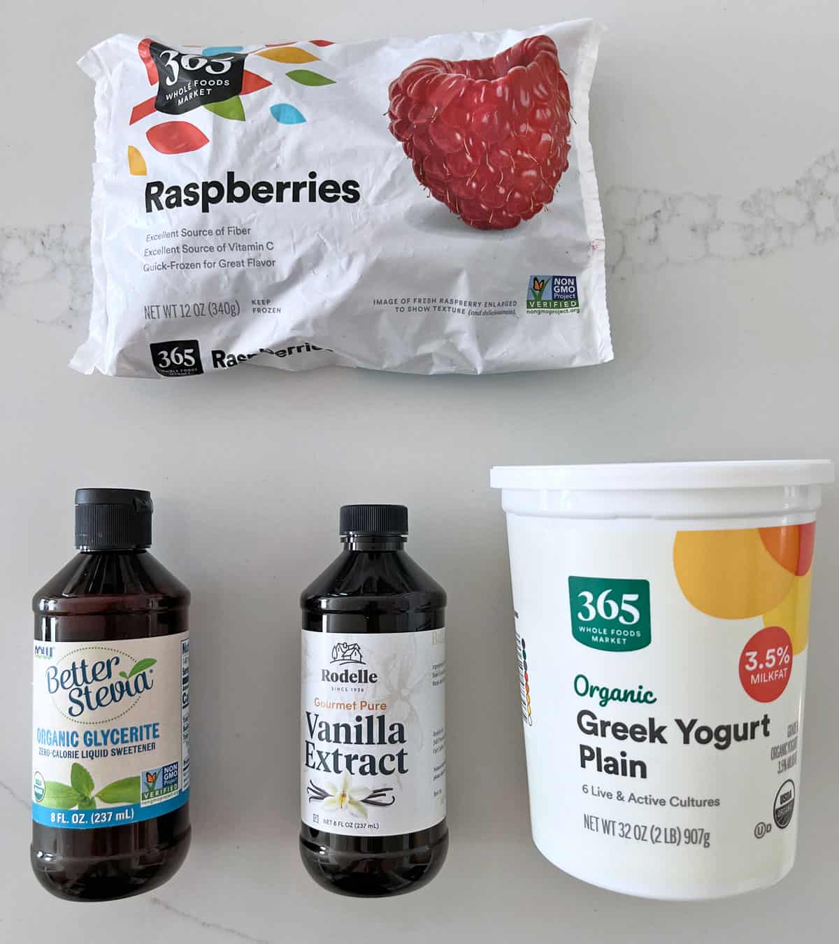 The ingredients needed to make raspberry frozen yogurt.