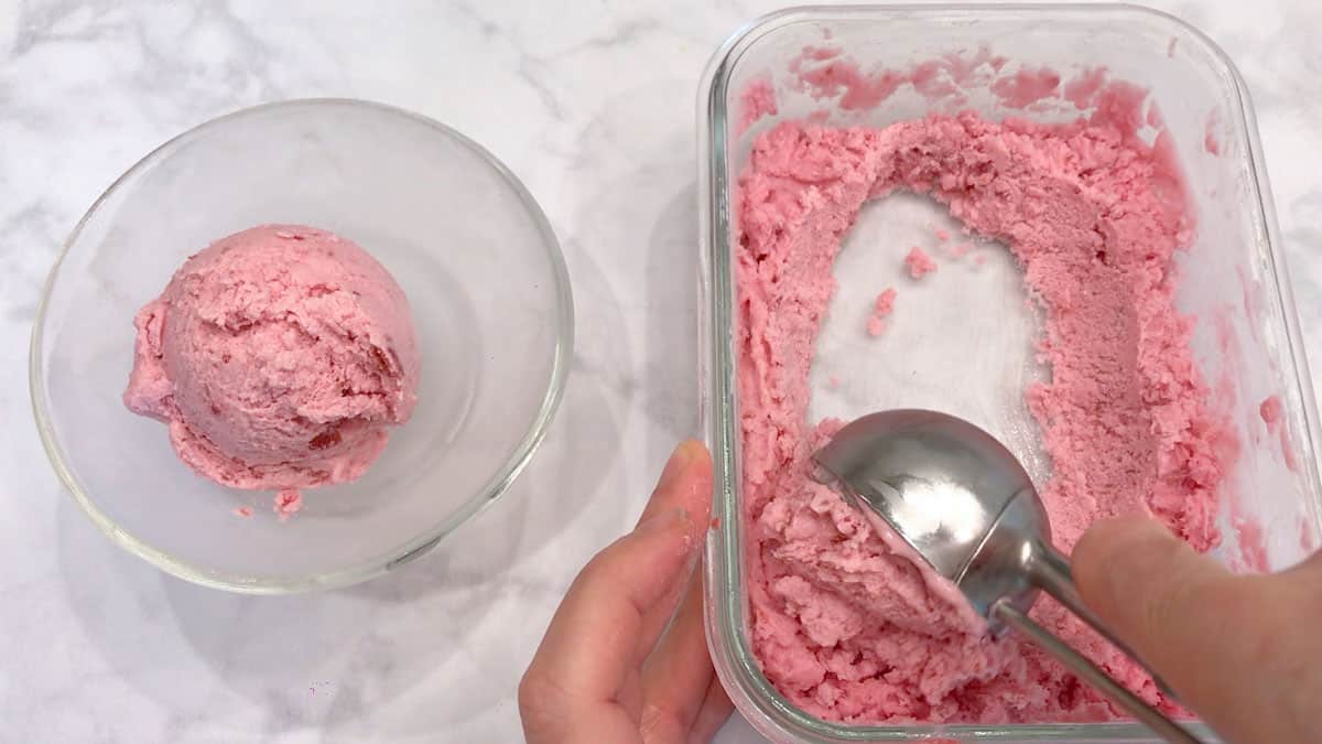 Scooping the yogurt onto a bowl.